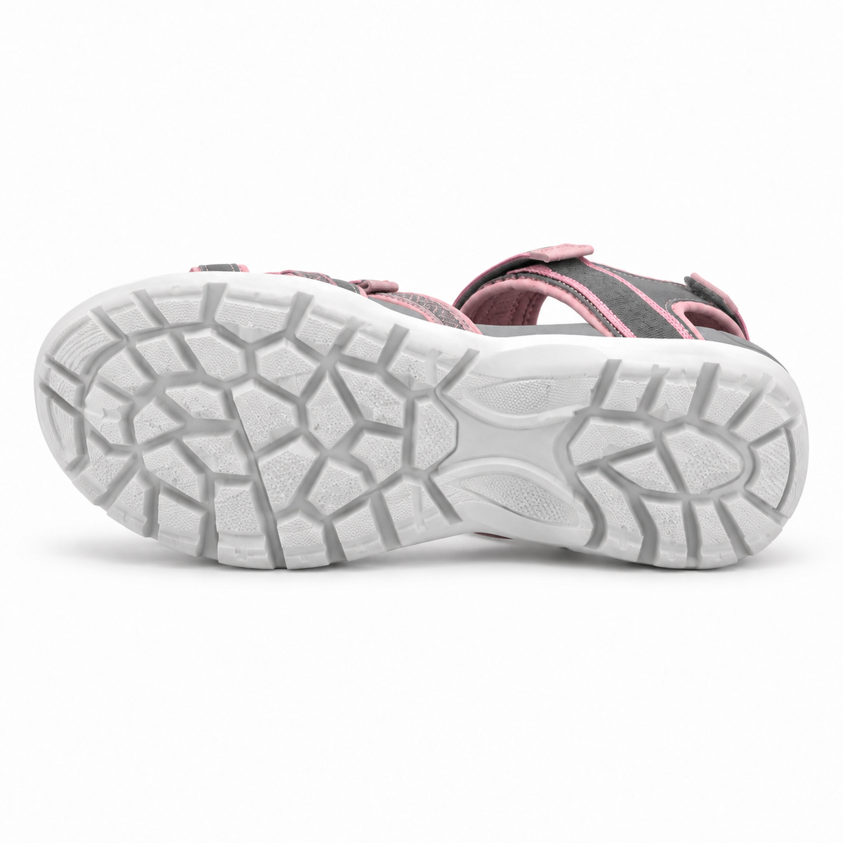 Sandale trekking femme rose posée sur le côté avec semelle complète attachée face à l’objectif