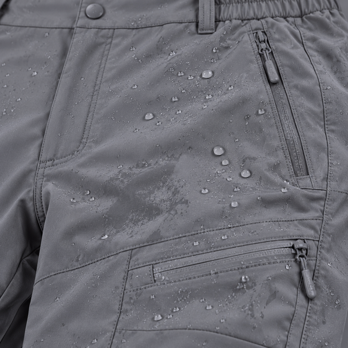 Gouttes sur le tissu du pantalon randonnée gris homme