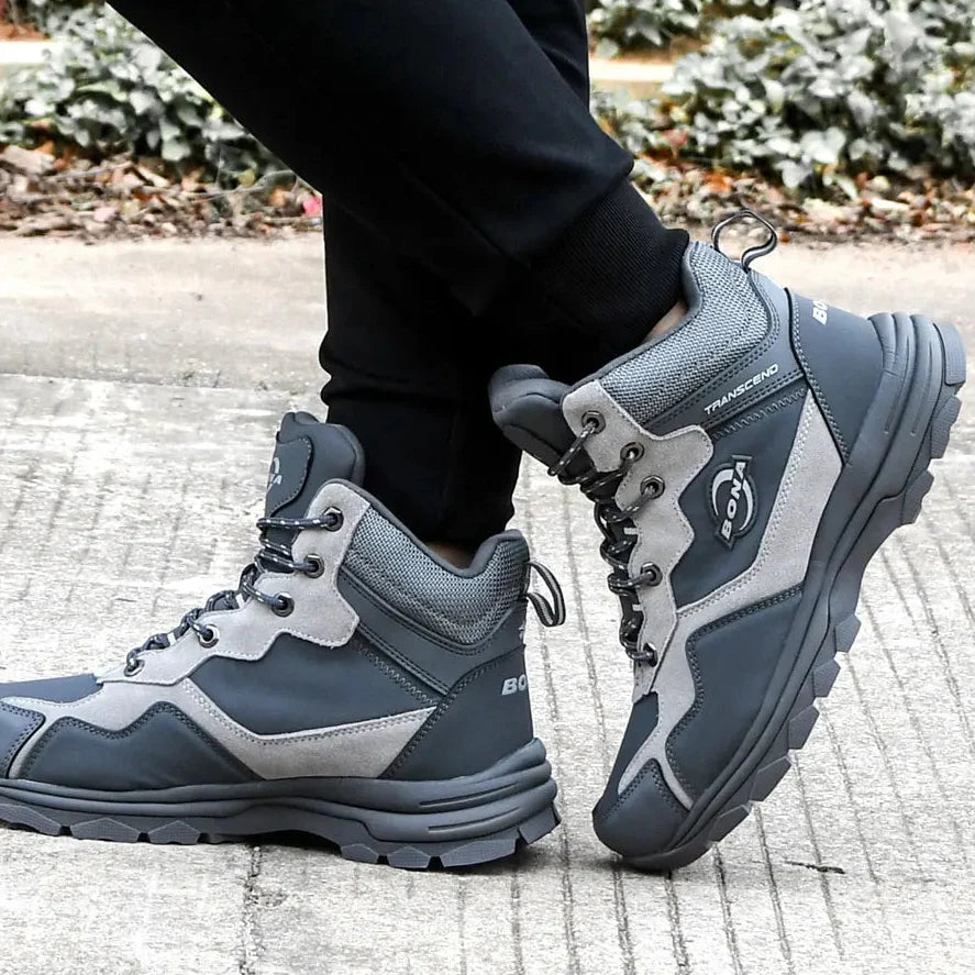 Dark gray and light gray high-top hiking boots with a rugged, textured sole and reinforced stitching